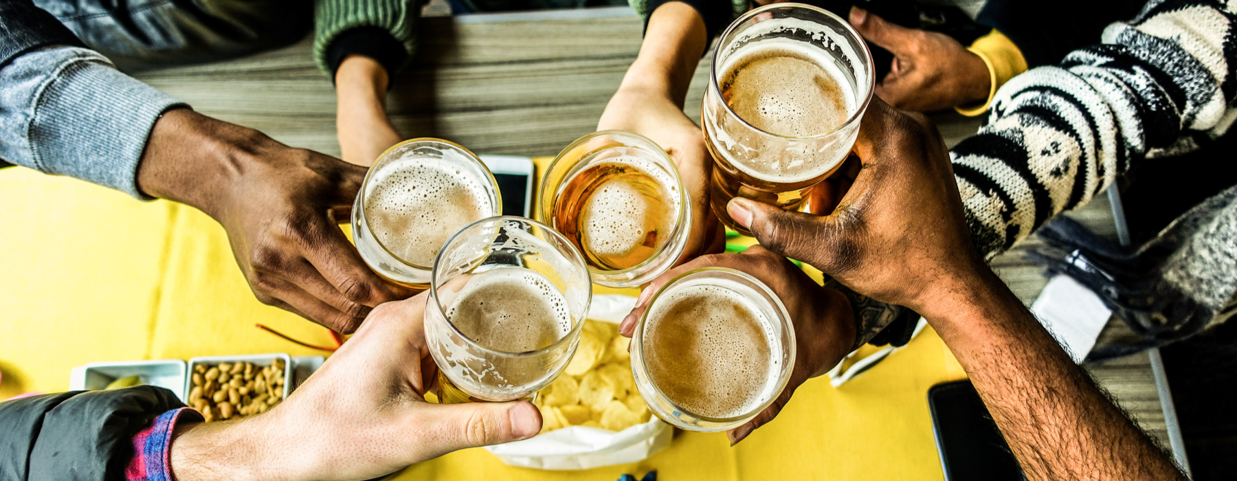 Group of people drinking beer at a pub.