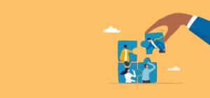 Picture of hand placing final piece of a jigsaw puzzle of people